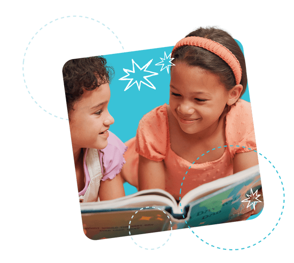 Two young girls laughing while holding a large book open in front of their face, surrounded by a blue background and illustrated circle graphics
