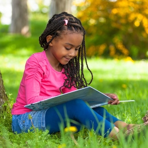 A girl reading in the grass