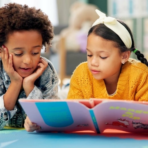 Boy and girl reading together